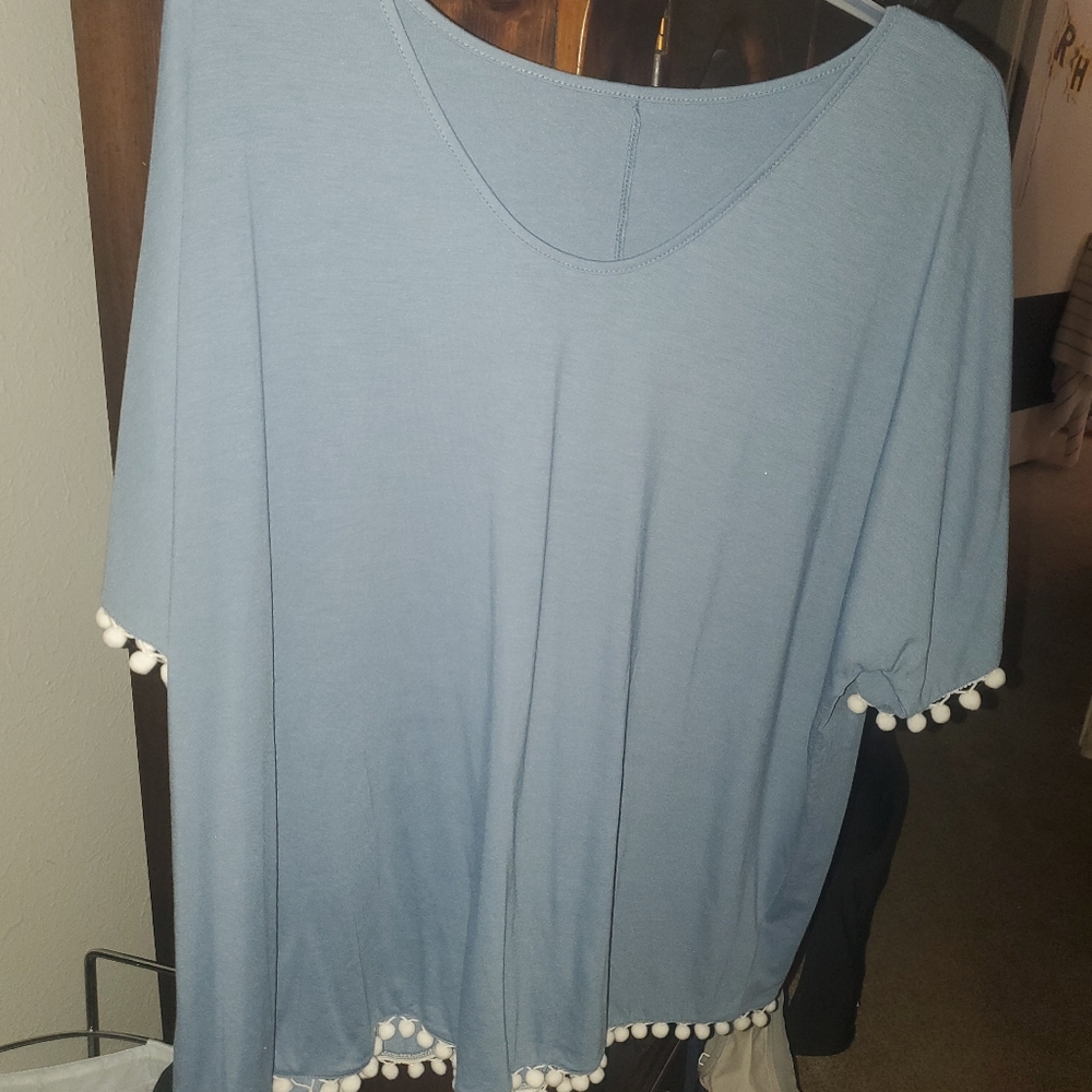 Blue shirt with pom poms